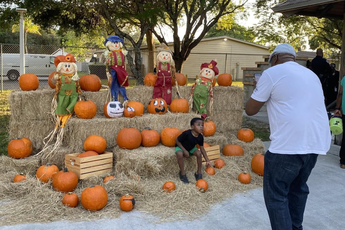 Child Taking Pictures in the Pumpkin Patch